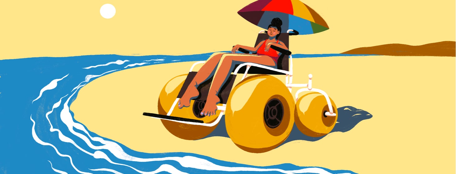 alt=a woman relaxes by the beach in a motorized power beach wheelchair.