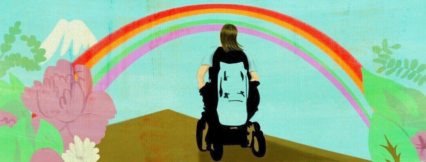 A person in a motorized wheelchair moves towards a rainbow