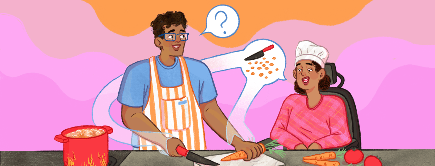 A man is cooking and preparing to chop carrots as he asks a question of a woman in a wheelchair who answers, her speech bubble forms hands that guide his