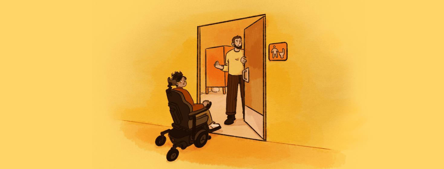 A bearded man holds open the door of a public mens room and waves in a woman in a powered wheelchair