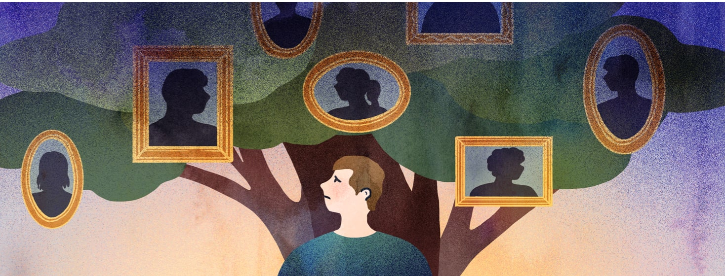 A man looks up at pictures of his family tree.